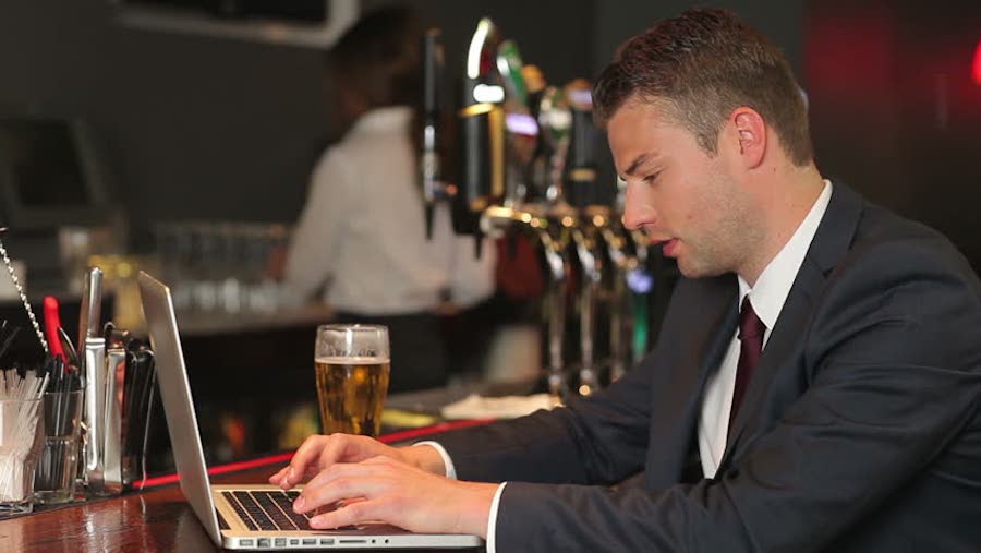Man in pub on laptop